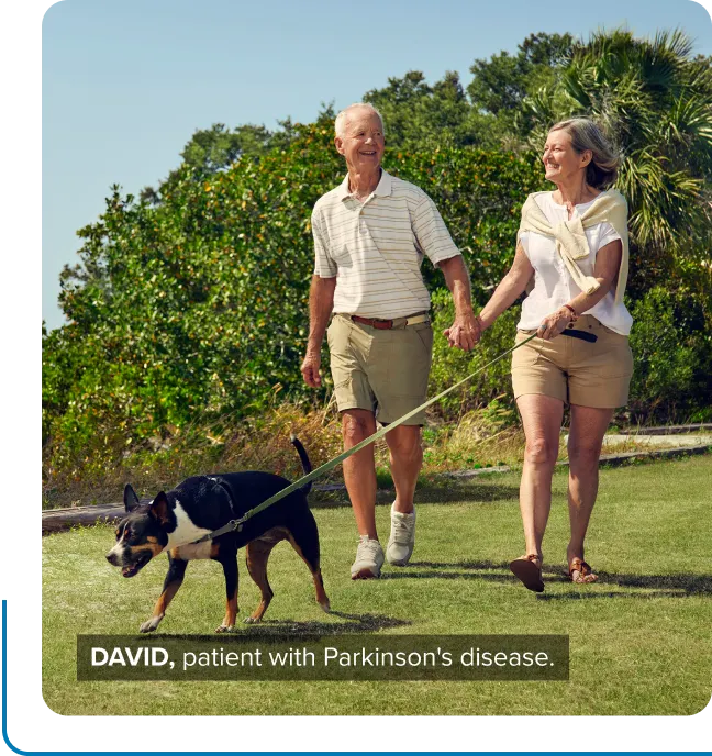 David, a patient with Parkinson’s disease, and his wife walking their dog