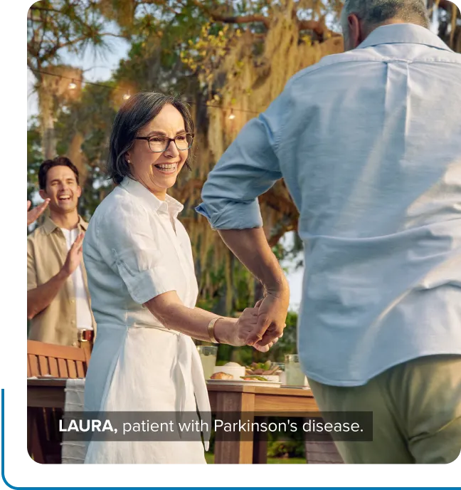 Laura, a patient with Parkinson's disease, dancing with a man outside