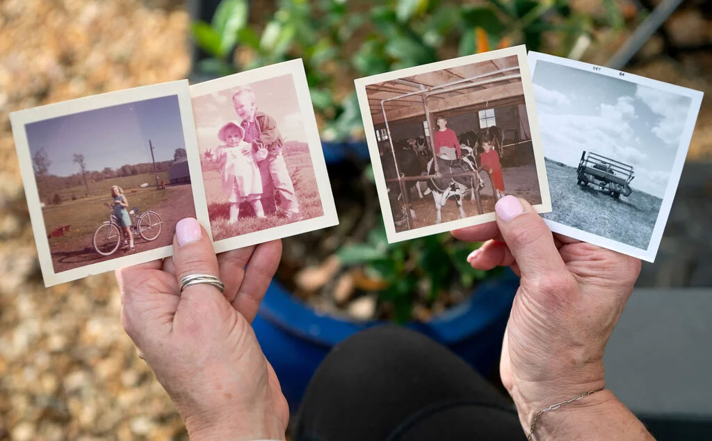 Image of Lori holding childhood photos.