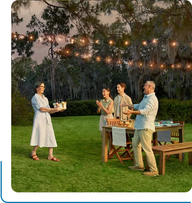 Image of Laura, a patient with Parkinson’s disease, and her family enjoy a picnic together.