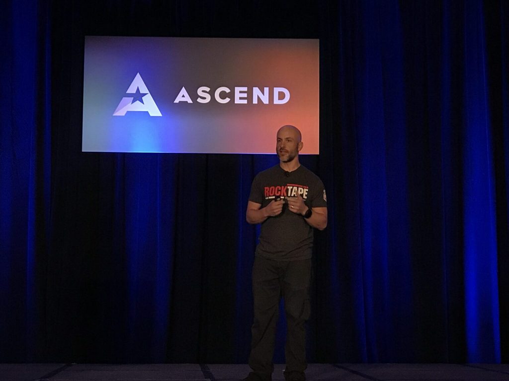 Image of real CREXONT patient, Stuart, on stage sharing his story about Parkinson’s disease.