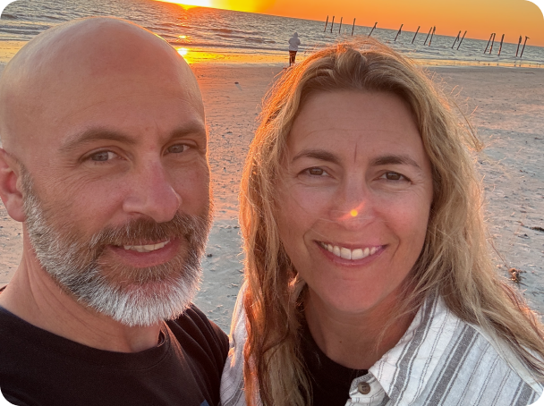 Image of real CREXONT patient, Stuart, with his wife on the beach.